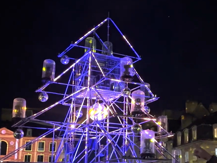 we are kraft met en lumière la place saint sauveur avec un show melant mapping video et show lumières. Au rythme des musiques de Noel, la place s'anime avec comme maître Snova, l'arbre lumière.